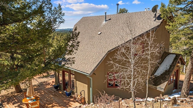 174 Needle Creek Rd, Divide, CO 80814 - view of property exterior featuring stucco siding, a deck, and a shingled roof