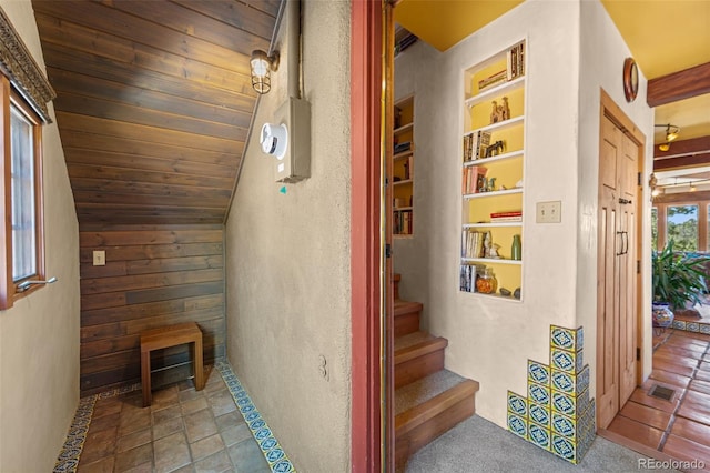 174 Needle Creek Rd, Divide, CO 80814 - staircase with lofted ceiling and wood walls