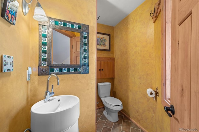 174 Needle Creek Rd, Divide, CO 80814 - half bath featuring toilet, a sink, and tile patterned flooring