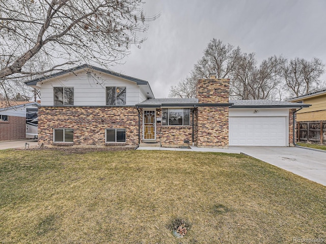 split level home with a front yard and brick siding