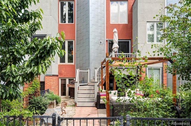 377 Pearl St Unit 5, Boulder, CO 80302 - view of front facade with stairway, a fenced front yard, and brick siding