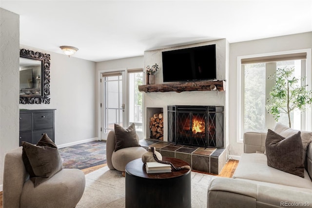377 Pearl St Unit 5, Boulder, CO 80302 - living room featuring a tiled fireplace and baseboards