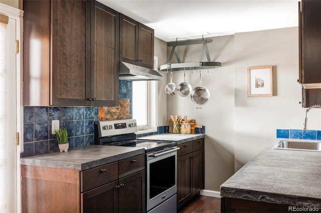 377 Pearl St Unit 5, Boulder, CO 80302 - kitchen with stainless steel range with electric stovetop, under cabinet range hood, decorative backsplash, and dark brown cabinetry