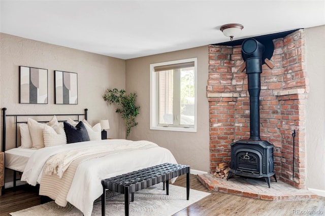 377 Pearl St Unit 5, Boulder, CO 80302 - bedroom featuring wood finished floors and a wood stove