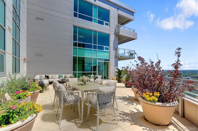2001 Lincoln St Unit 2524, Denver, CO 80202 - view of patio featuring a balcony, outdoor dining area, and an outdoor hangout area