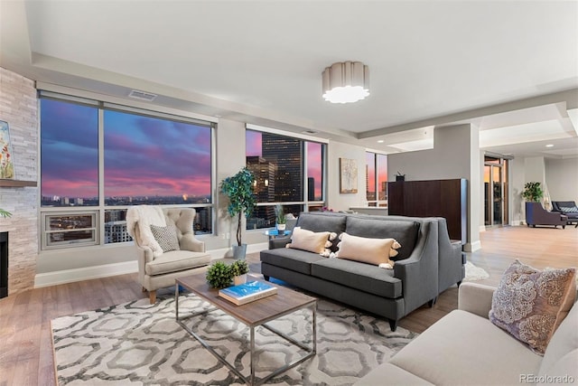 2001 Lincoln St Unit 2524, Denver, CO 80202 - living room featuring wood finished floors, baseboards, and a large fireplace