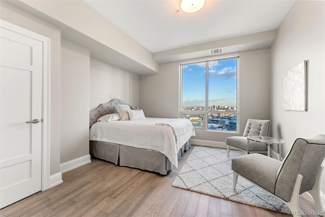 2001 Lincoln St Unit 2524, Denver, CO 80202 - bedroom with baseboards and wood finished floors