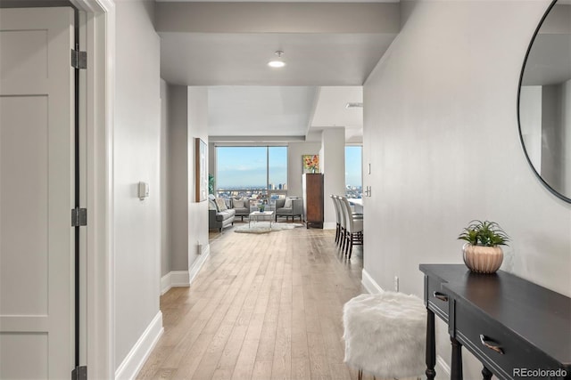 2001 Lincoln St Unit 2524, Denver, CO 80202 - hallway with baseboards, light wood-style flooring, and recessed lighting