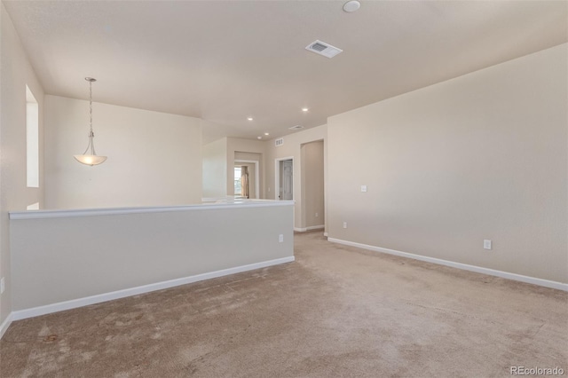 empty room featuring carpet, visible vents, baseboards, and recessed lighting