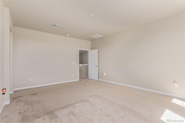 unfurnished room with light colored carpet, baseboards, and visible vents