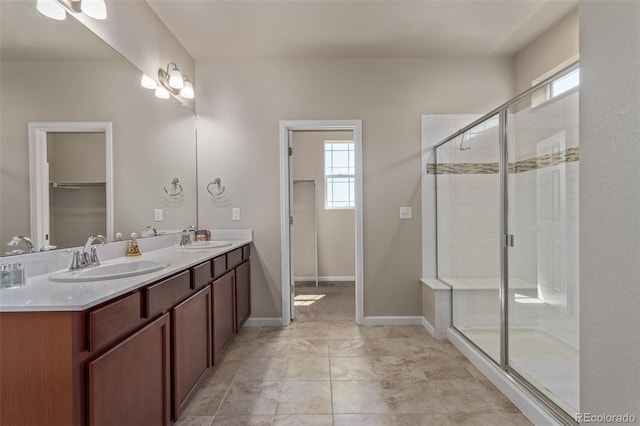 full bath featuring a wealth of natural light, a stall shower, and a sink