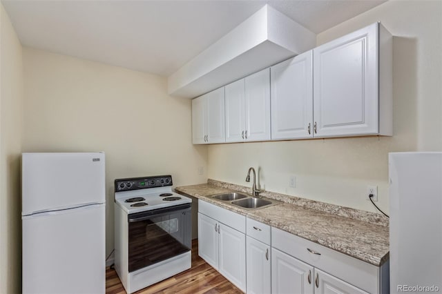 kitchen featuring white cabinetry, white appliances, light wood-type flooring, and a sink