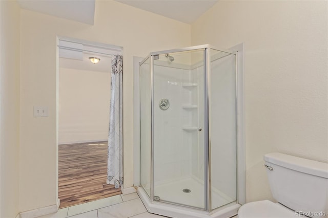 full bath featuring toilet and a shower stall
