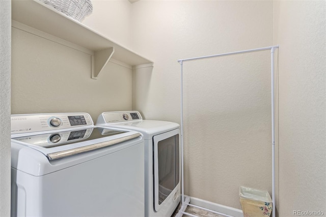 laundry room featuring separate washer and dryer and laundry area