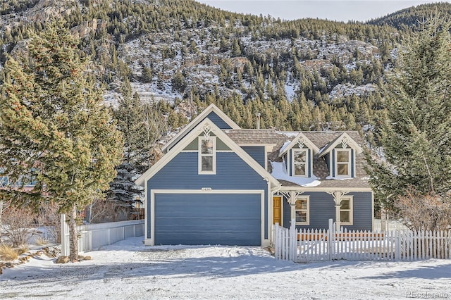 view of front of property with a mountain view and a garage