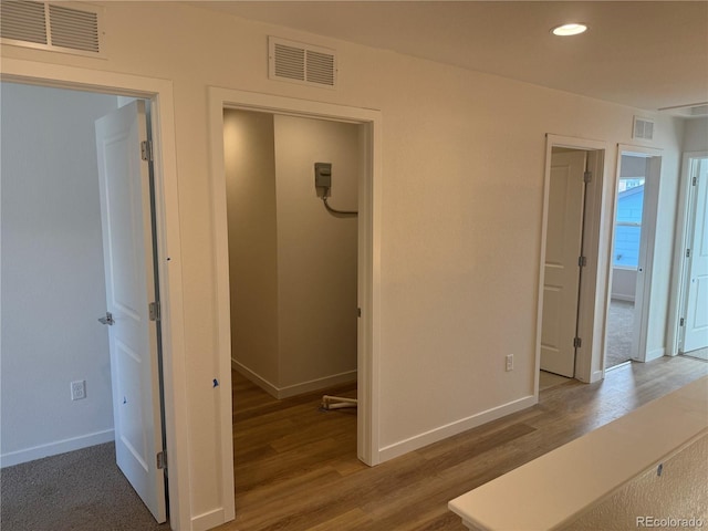 corridor featuring visible vents and wood finished floors