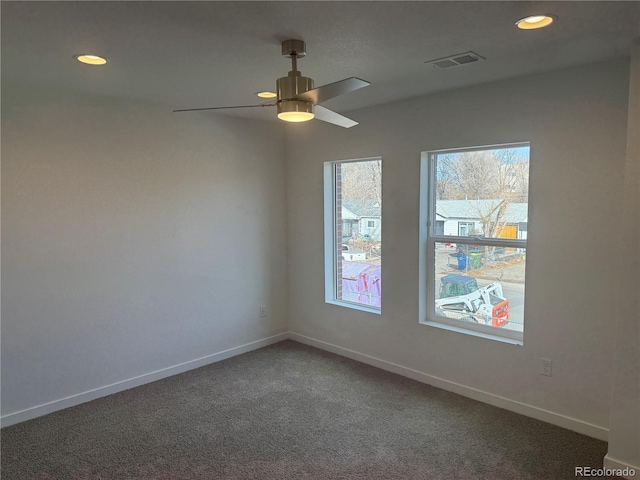 spare room featuring carpet, visible vents, baseboards, and recessed lighting