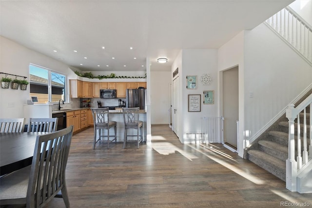 dining room featuring dark wood-type flooring and sink