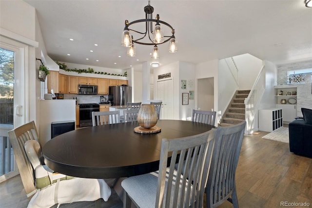 dining room with dark hardwood / wood-style floors and a chandelier