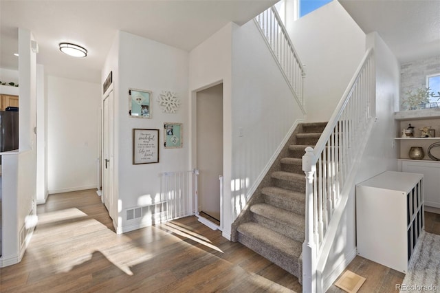 stairway featuring wood-type flooring