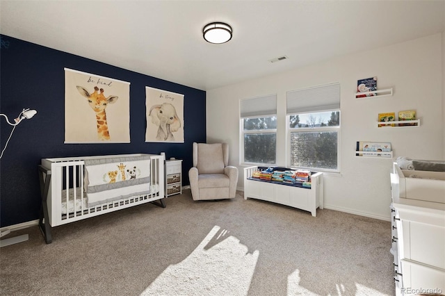 carpeted bedroom with a crib