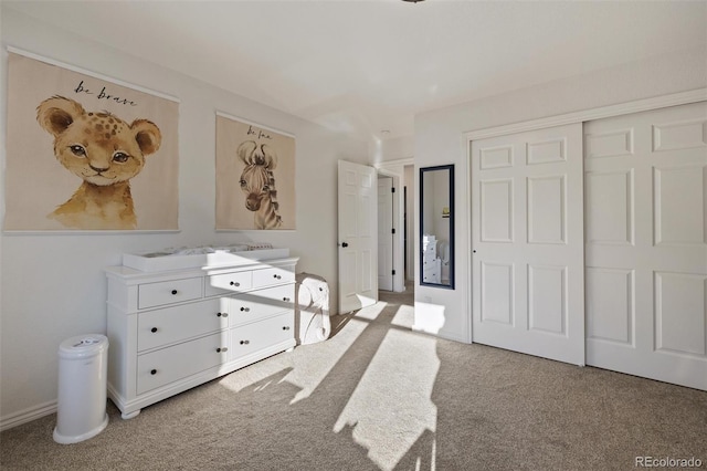 unfurnished bedroom with light colored carpet and a closet