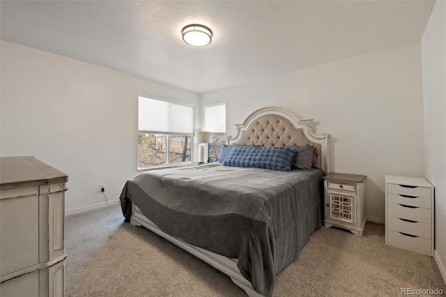 bedroom with light carpet and a textured ceiling