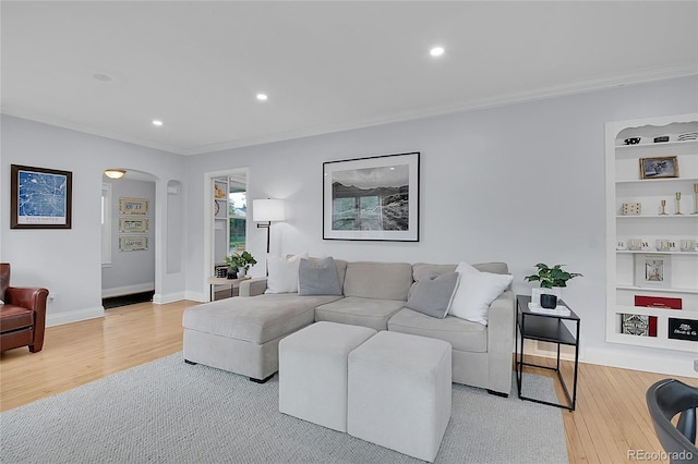2212 Ingalls St, Edgewater, CO 80214 - living room with arched walkways, crown molding, light wood-type flooring, recessed lighting, and built in features