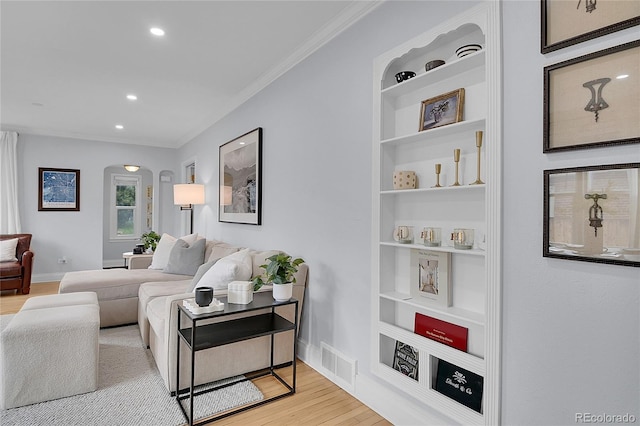 2212 Ingalls St, Edgewater, CO 80214 - living room featuring arched walkways, wood finished floors, ornamental molding, and recessed lighting