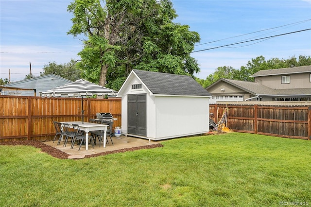 2212 Ingalls St, Edgewater, CO 80214 - fenced backyard featuring a storage unit and a patio area