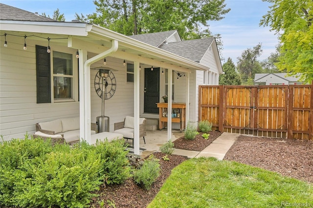 2212 Ingalls St, Edgewater, CO 80214 - entrance to property featuring roof with shingles and outdoor lounge area