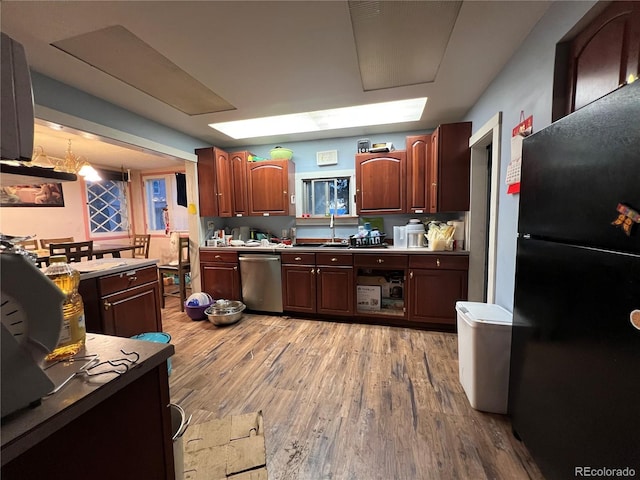 1069 US Highway 285, Monte Vista, CO 81144 - kitchen with freestanding refrigerator, dishwasher, and light wood-style floors