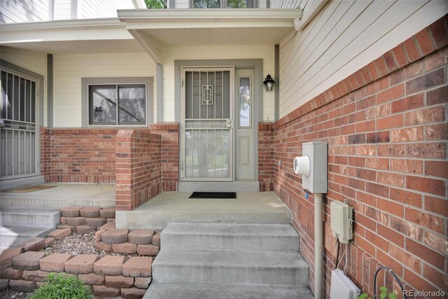 5283 Union Ct Unit 8, Arvada, CO 80002 - view of exterior entry with brick siding and covered porch