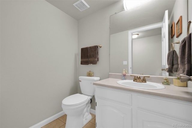 5283 Union Ct Unit 8, Arvada, CO 80002 - half bathroom featuring tile patterned flooring, toilet, vanity, and baseboards