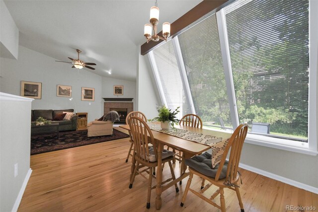 5283 Union Ct Unit 8, Arvada, CO 80002 - dining room with a fireplace, wood finished floors, vaulted ceiling, baseboards, and a ceiling fan