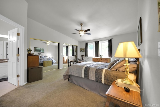5283 Union Ct Unit 8, Arvada, CO 80002 - carpeted bedroom featuring vaulted ceiling, ensuite bathroom, a ceiling fan, and two closets