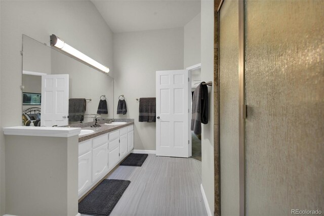 5283 Union Ct Unit 8, Arvada, CO 80002 - bathroom featuring double vanity and baseboards