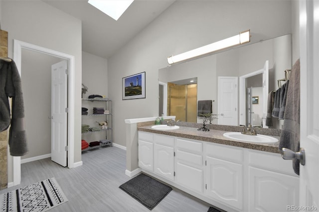 5283 Union Ct Unit 8, Arvada, CO 80002 - full bath featuring a skylight, double vanity, lofted ceiling, wood finished floors, and baseboards