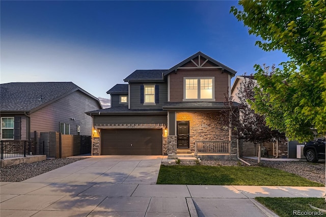 15595 E 47th Dr, Denver, CO 80239 - craftsman-style house featuring driveway, an attached garage, and stone siding