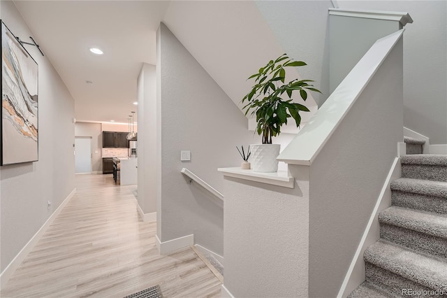 15595 E 47th Dr, Denver, CO 80239 - hall featuring wood finished floors, recessed lighting, and stairway
