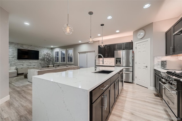 15595 E 47th Dr, Denver, CO 80239 - kitchen with appliances with stainless steel finishes, recessed lighting, pendant lighting, light wood finished floors, and light stone countertops