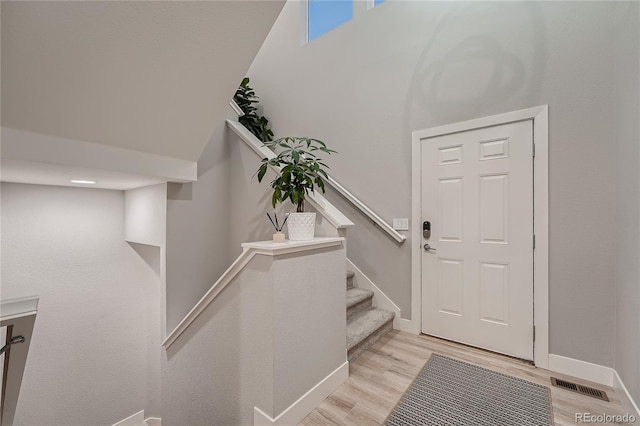 15595 E 47th Dr, Denver, CO 80239 - foyer entrance featuring light wood finished floors and stairway