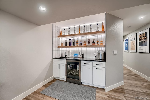 15595 E 47th Dr, Denver, CO 80239 - indoor wet bar with wine cooler, light wood finished floors, and recessed lighting