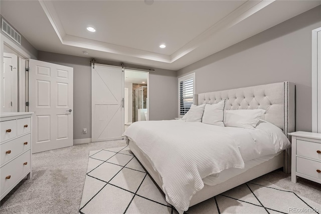 15595 E 47th Dr, Denver, CO 80239 - bedroom with a tray ceiling, a barn door, light colored carpet, recessed lighting, and ensuite bath