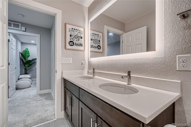 15595 E 47th Dr, Denver, CO 80239 - bathroom with double vanity and a textured wall