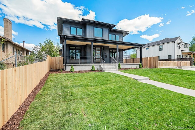 view of front of house featuring covered porch and a front yard