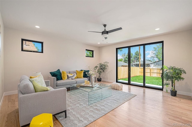 living room featuring hardwood / wood-style floors and ceiling fan