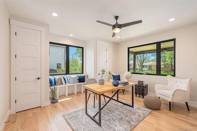 home office featuring light hardwood / wood-style floors and ceiling fan