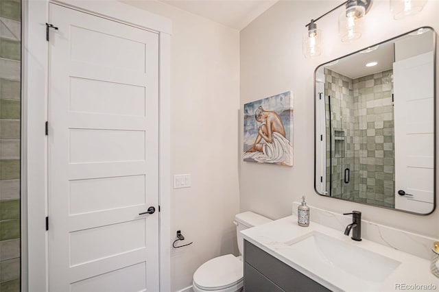 bathroom with a shower with door, toilet, and vanity