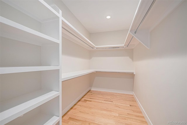 spacious closet featuring light hardwood / wood-style flooring